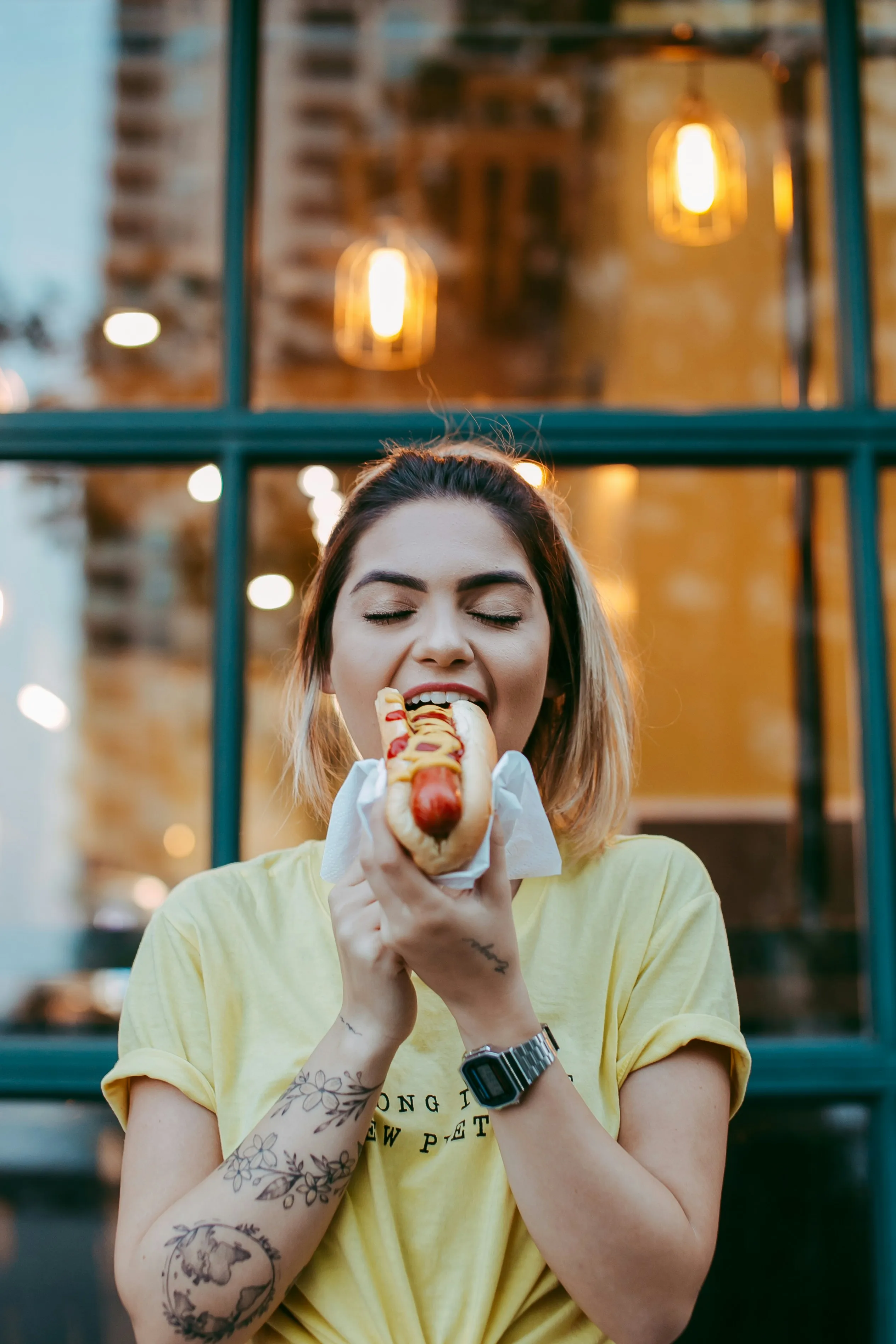 Woman eating a hotdog